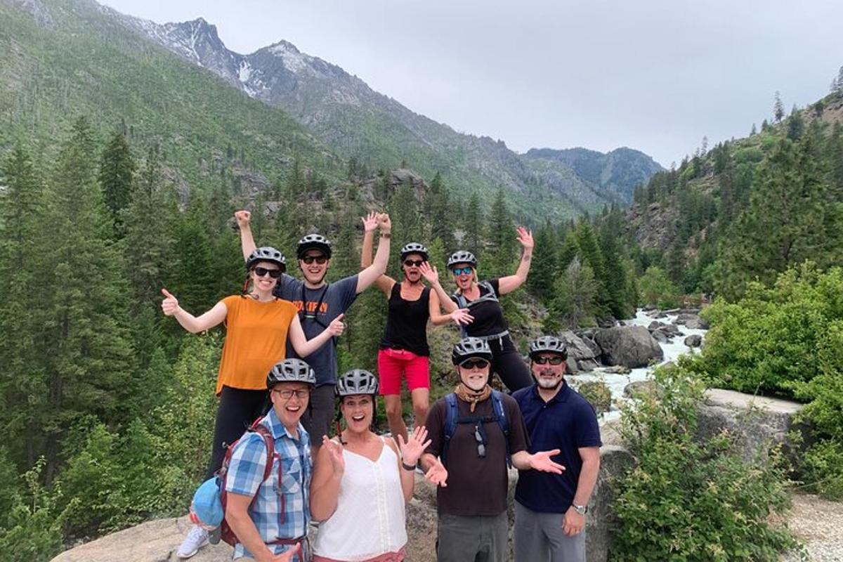 a group of people posing for a picture on a mountain