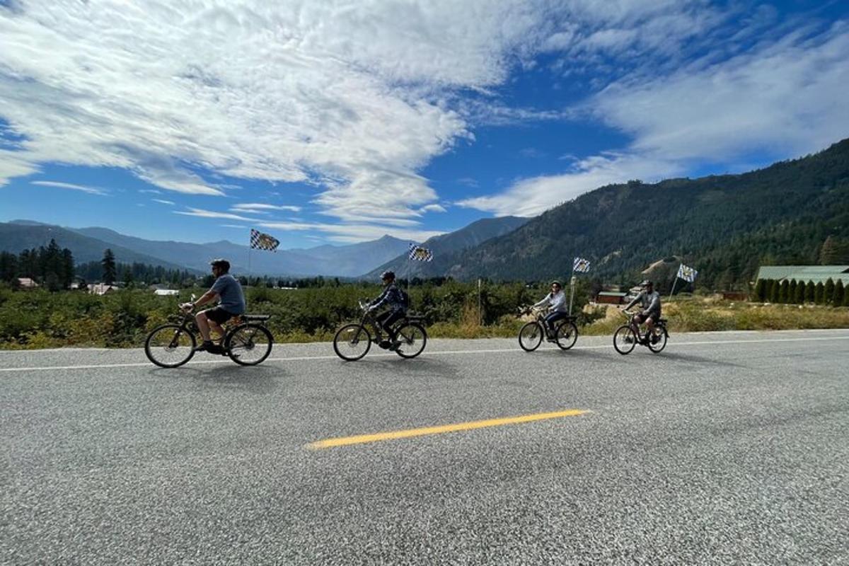 a group of people riding bikes down a road