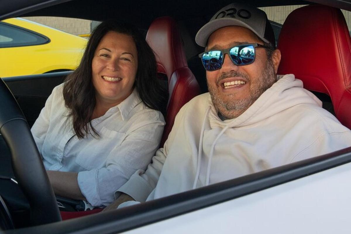 a man and a woman sitting in a car