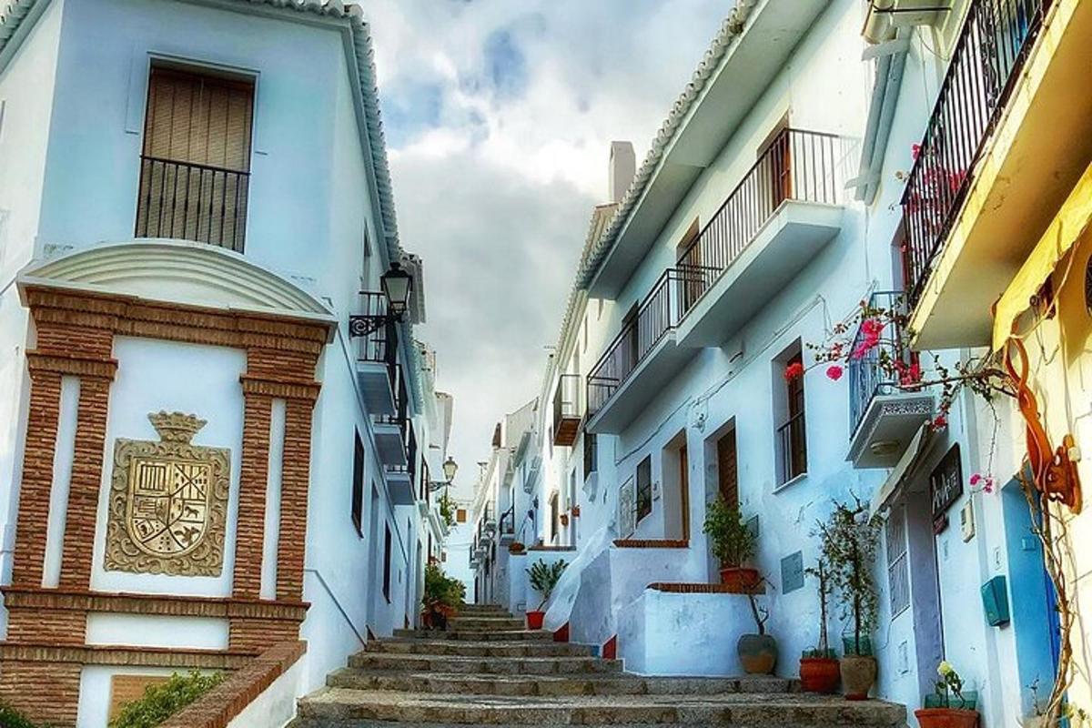 a narrow alley with stairs leading up to a building