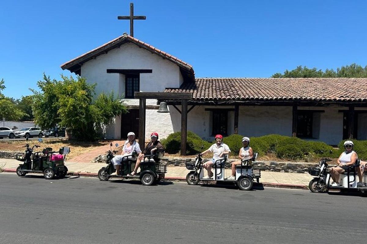 Un grupo de personas viajando en quads frente a una iglesia.