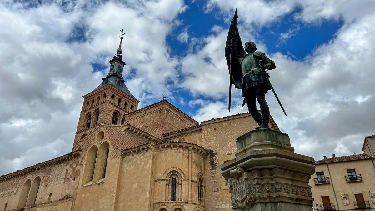 a statue of a man holding a flag in front of a building