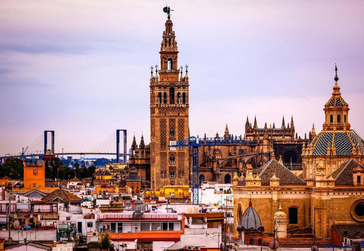 a city skyline with a clock tower and a bridge