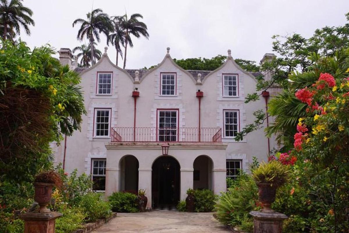 a large white house with a balcony on it