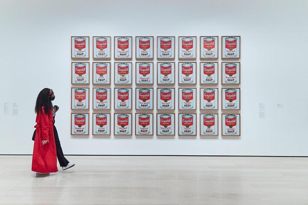 a woman walking in front of a museum exhibit