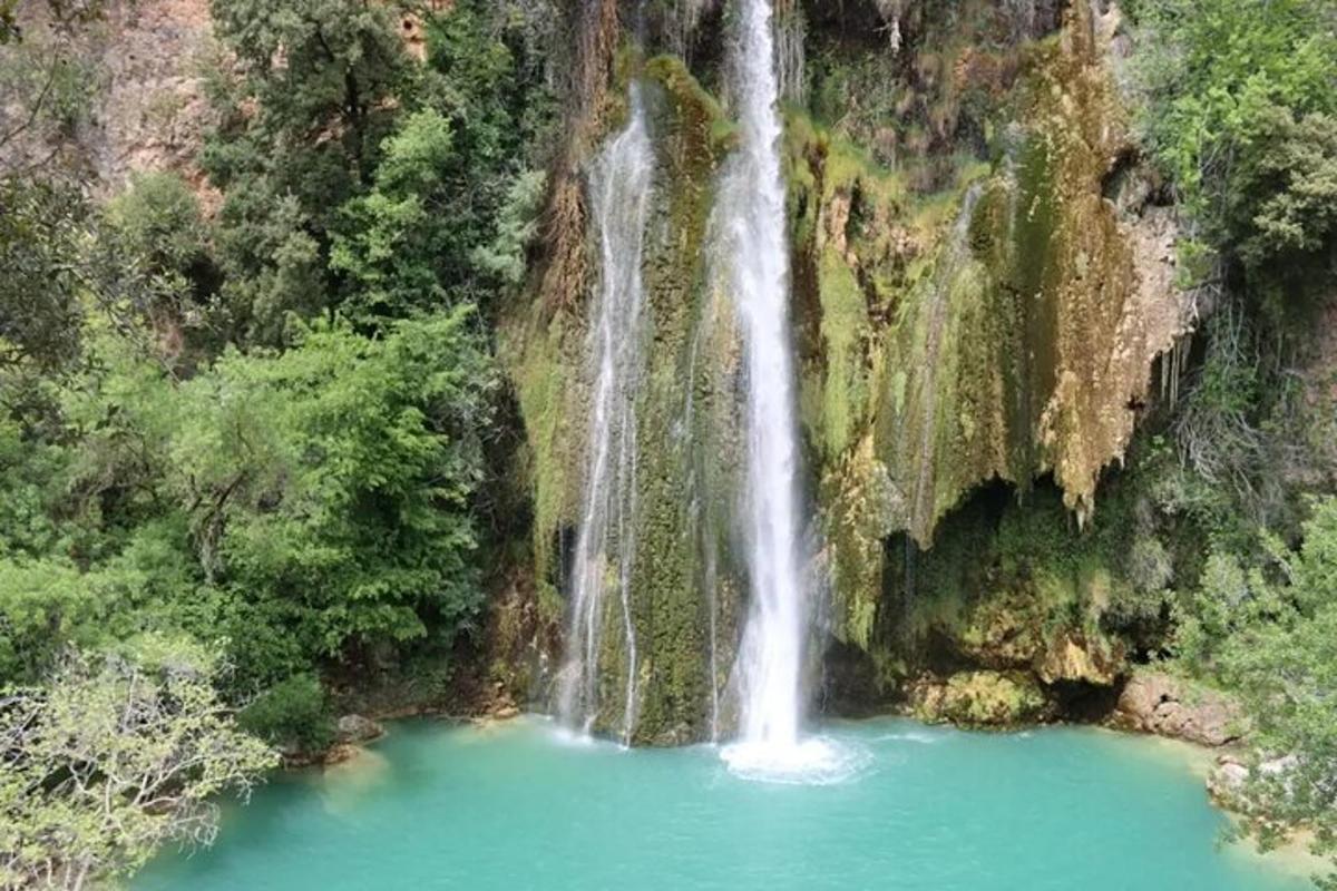 a waterfall in the middle of a pool of water
