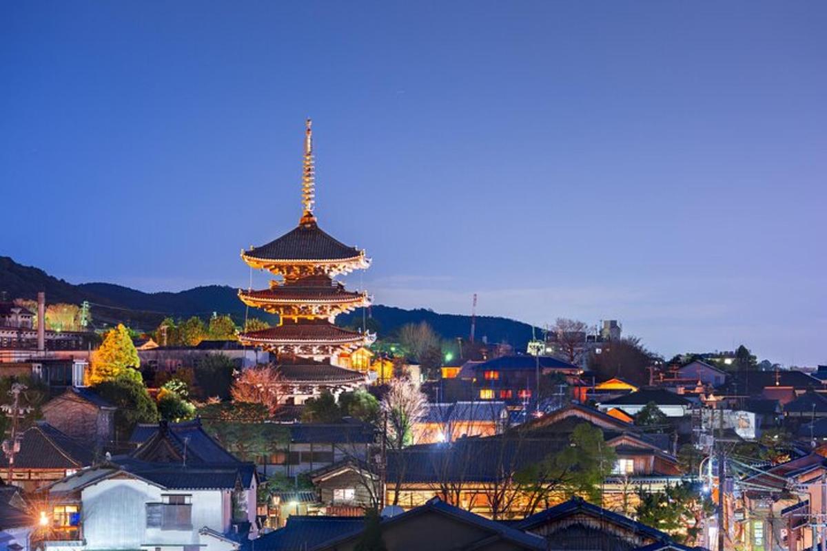 a lit up city with a pagoda in the distance