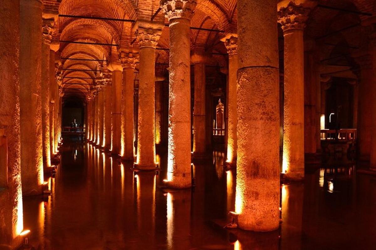 a row of columns in a large building with lights