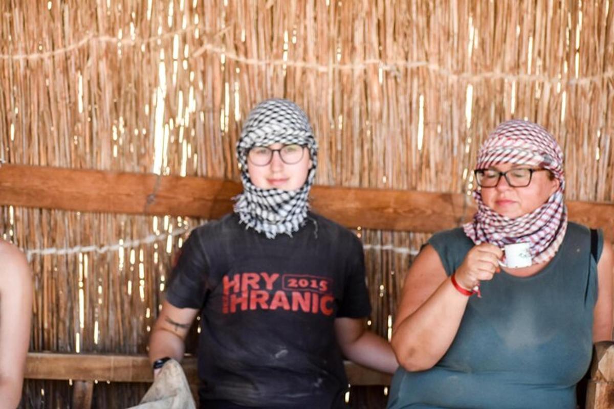 two women wearing hats and scarves standing next to each other