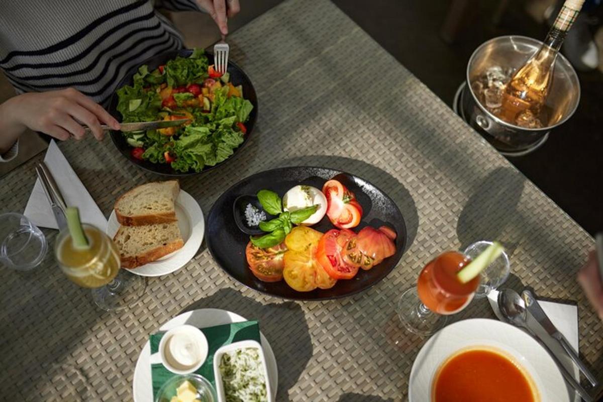 a table with two plates of food and a salad