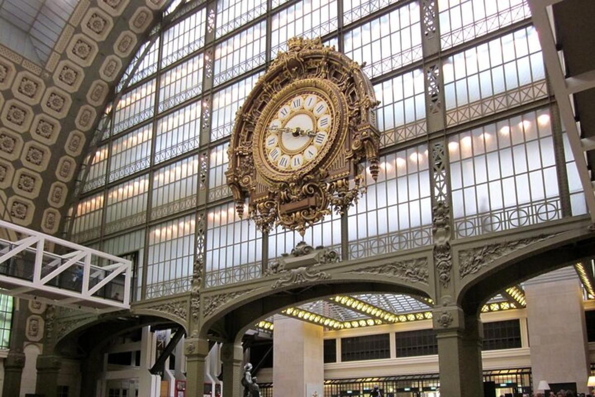 a large clock hanging from the ceiling of a building