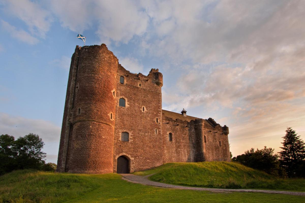 a castle on top of a grassy hill
