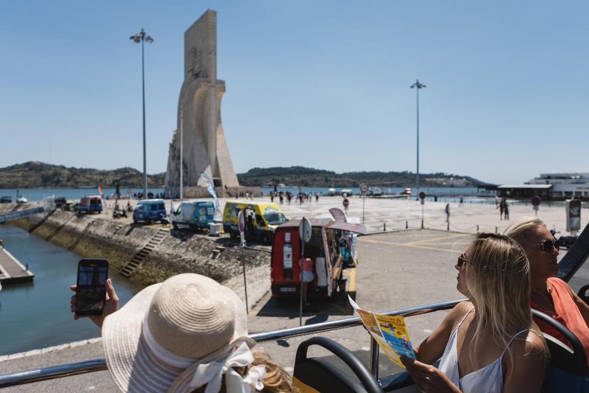 a group of people on a boat looking at the beach