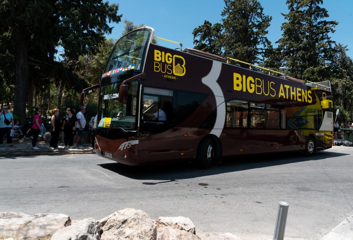 a double decker bus driving down a street