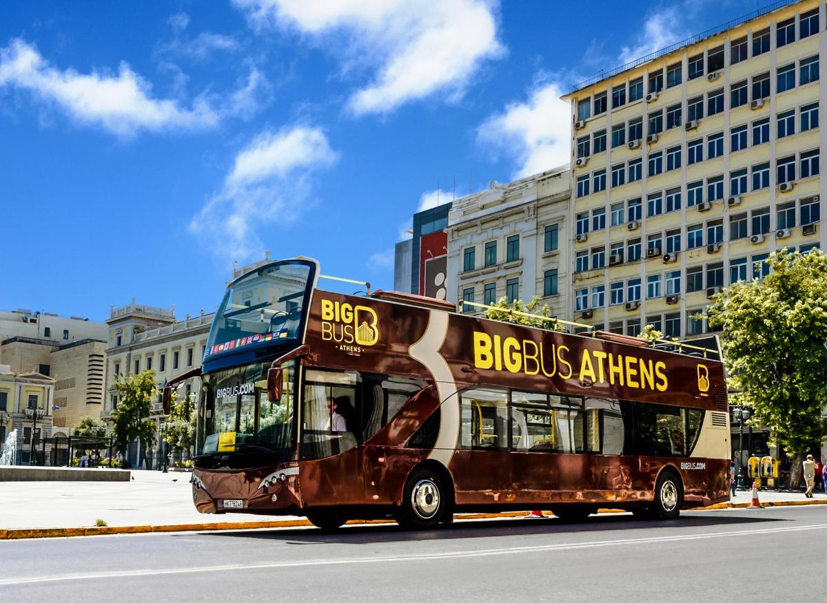 a double decker bus driving down a city street