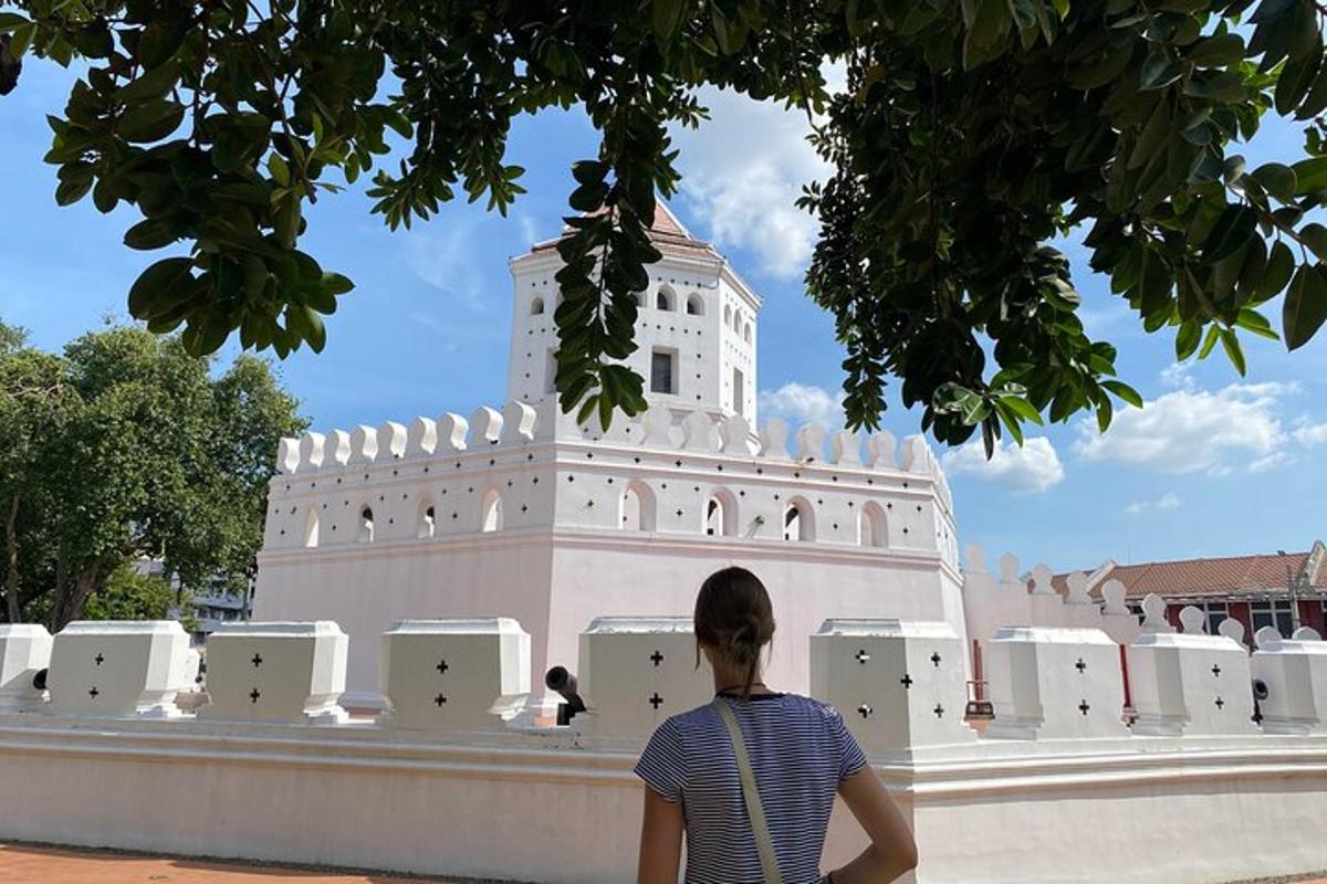 a person sitting on a wall in front of a building