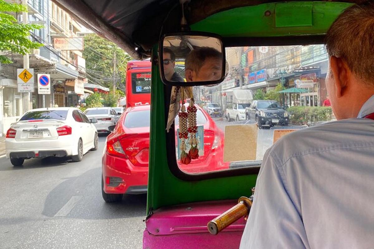 a man riding a bus down a busy city street