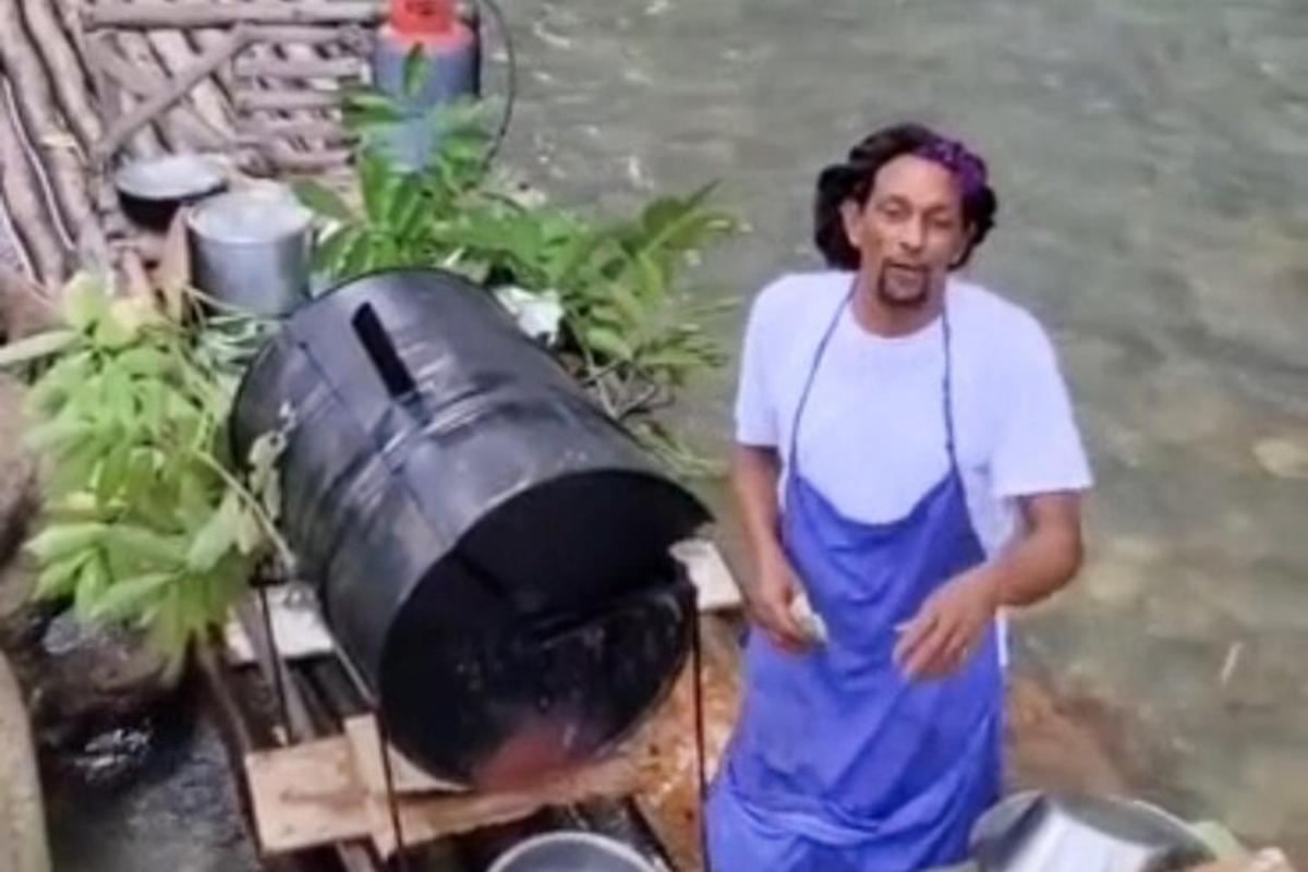 a man is standing next to a trash can
