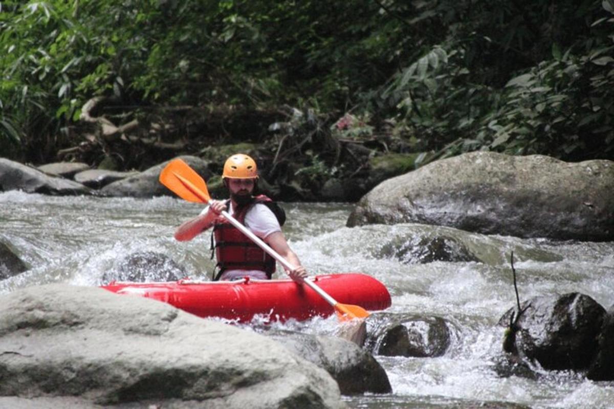 a person in a red kayak in a river