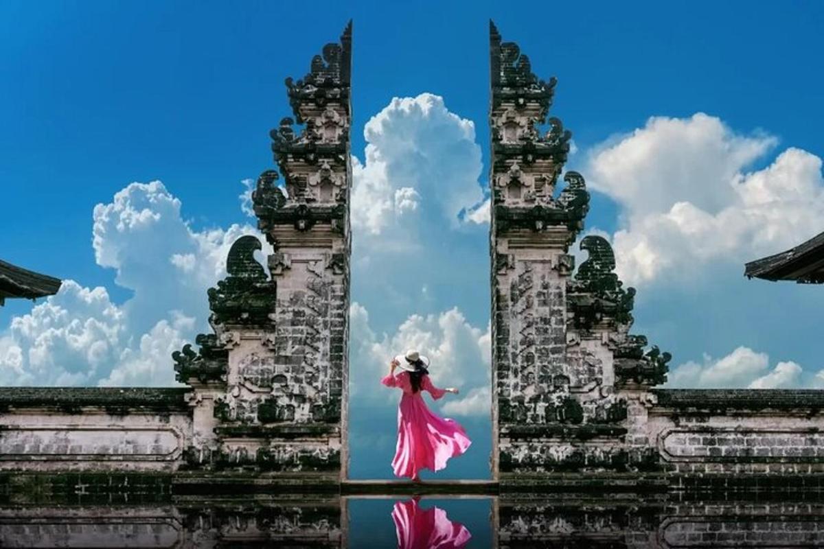 a woman in a pink dress in front of a building