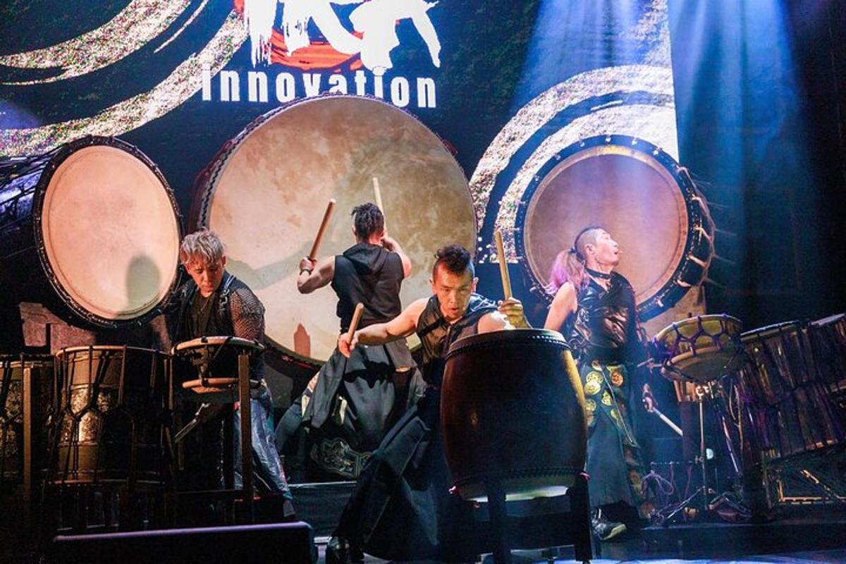 a group of people playing drums on a stage