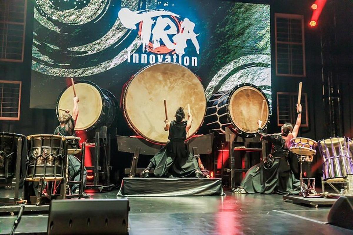 a group of people playing drums on a stage