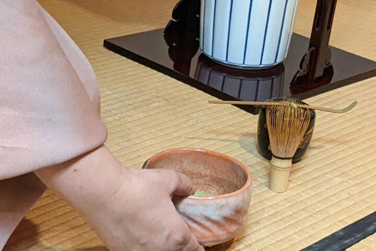 a person is holding a bowl with a brush