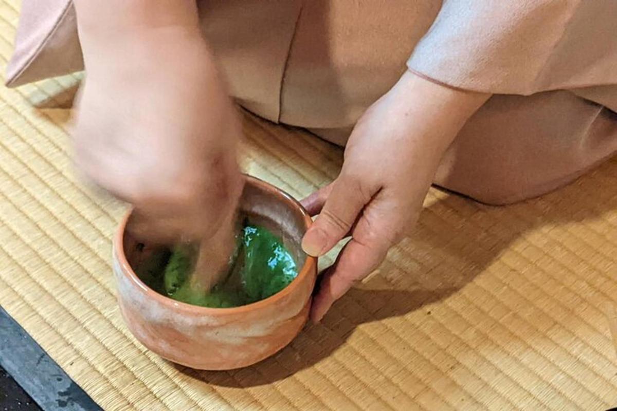 a person sitting on the floor with a bowl of liquid