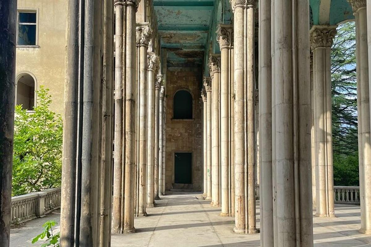 a row of columns of a building with a door