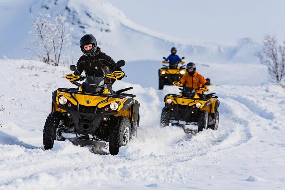 a group of people riding atvs in the snow