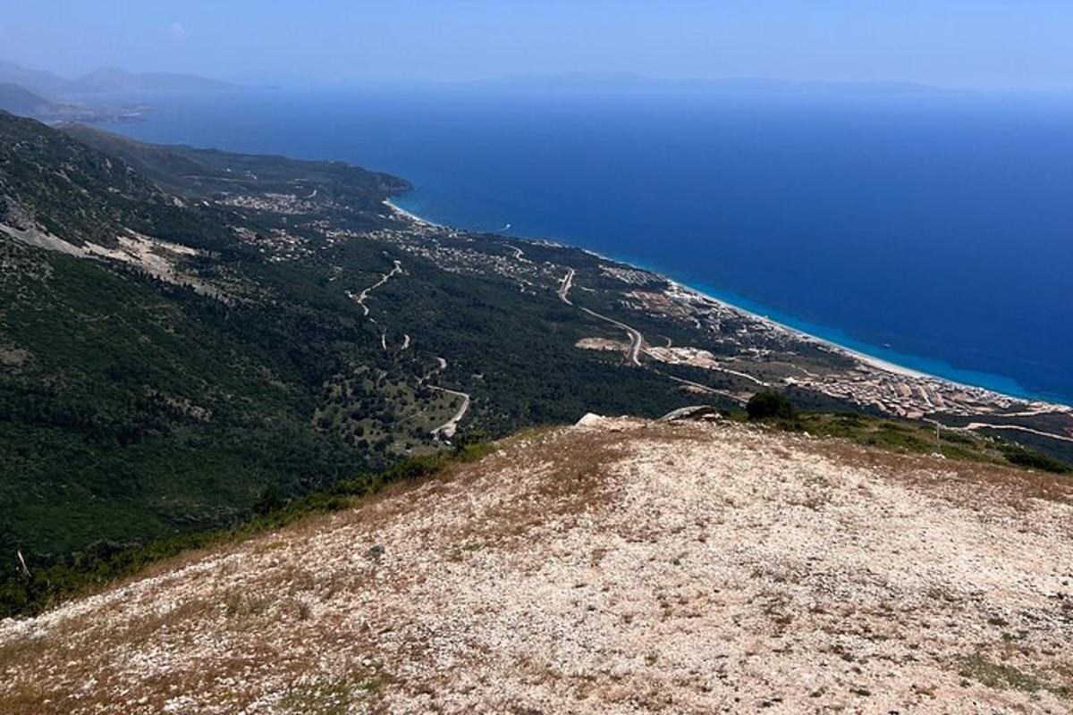 a view of a mountain with the blue ocean