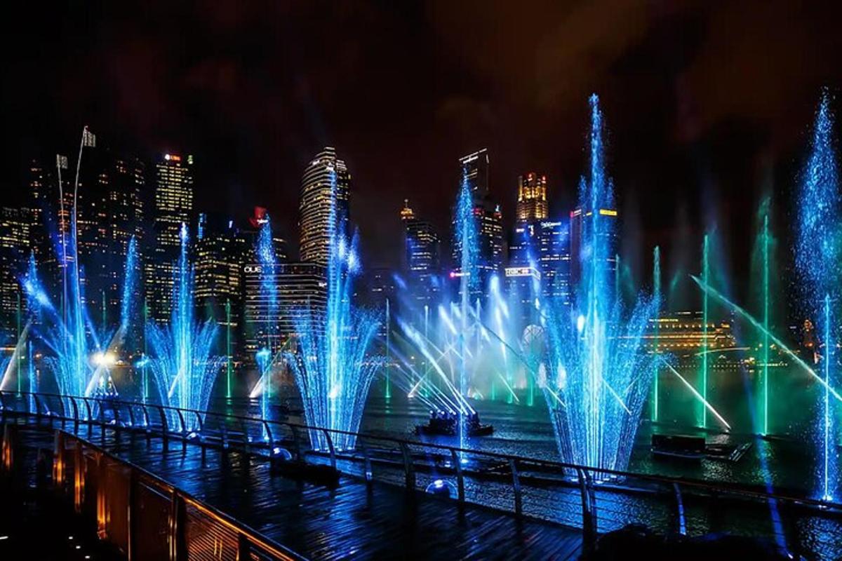 a water fountain in a city at night