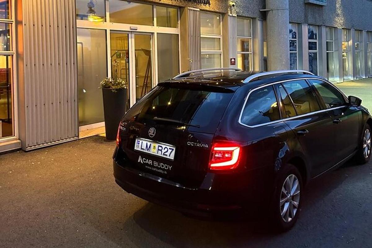 a black car parked in front of a building