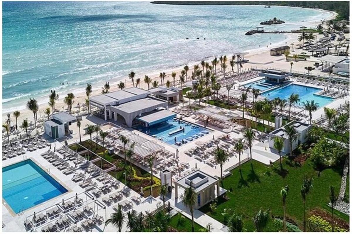 an aerial view of a resort with a beach
