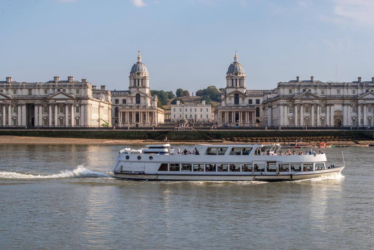 a boat on the river in front of a large building