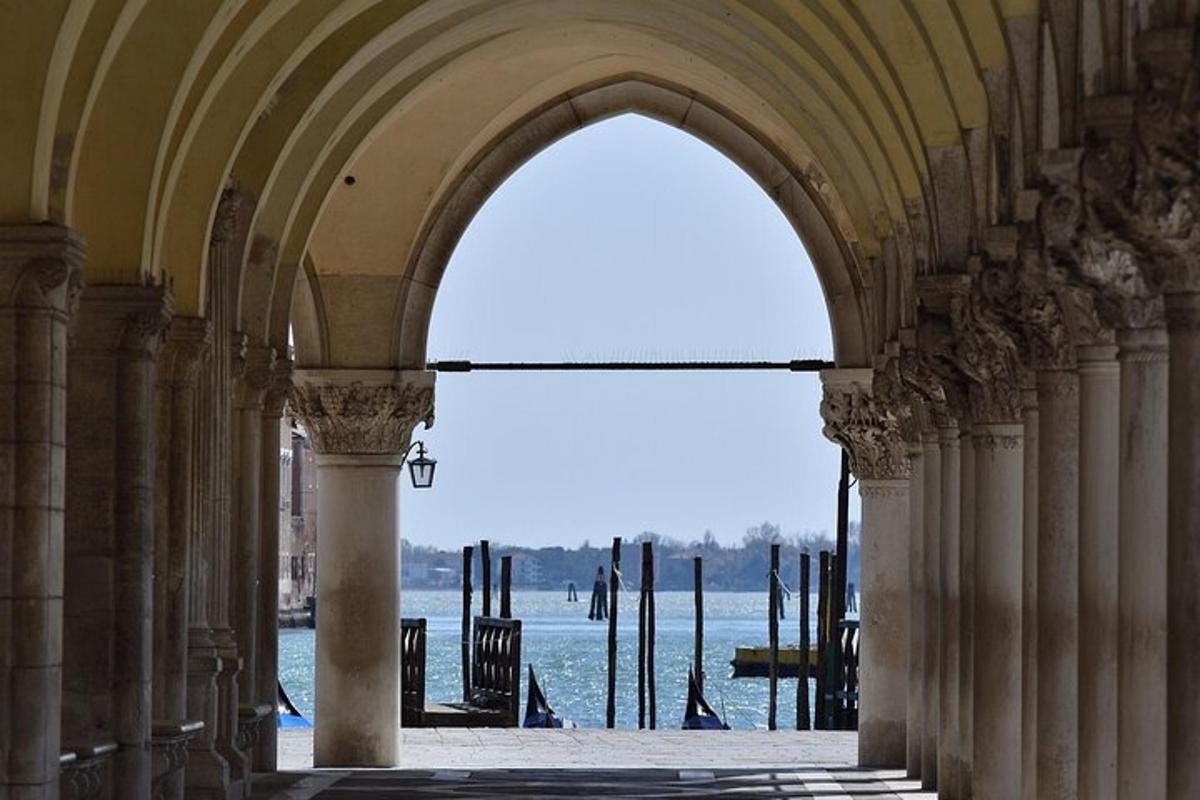 an archway in a building with a view of the water