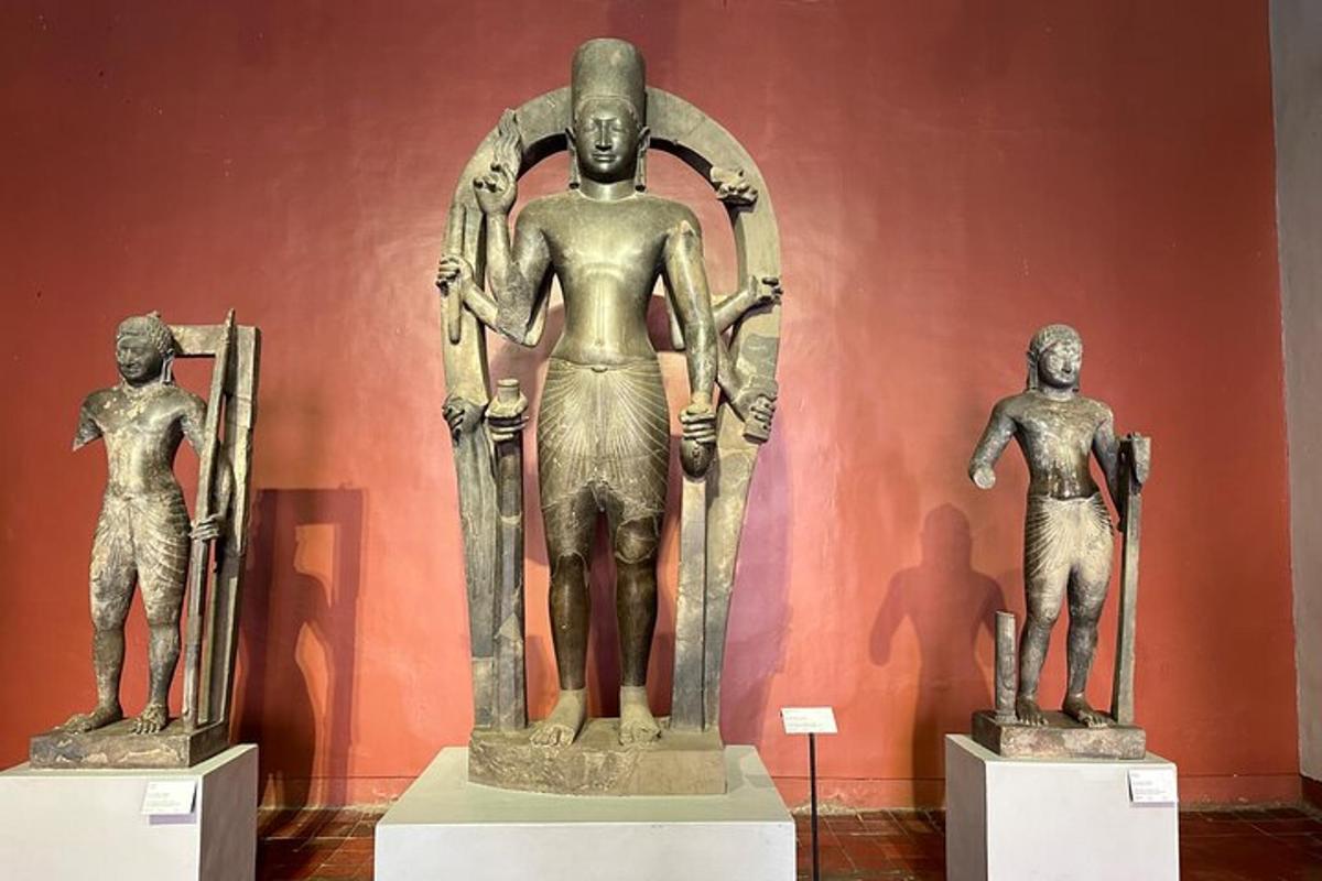 a group of statues on display in a museum
