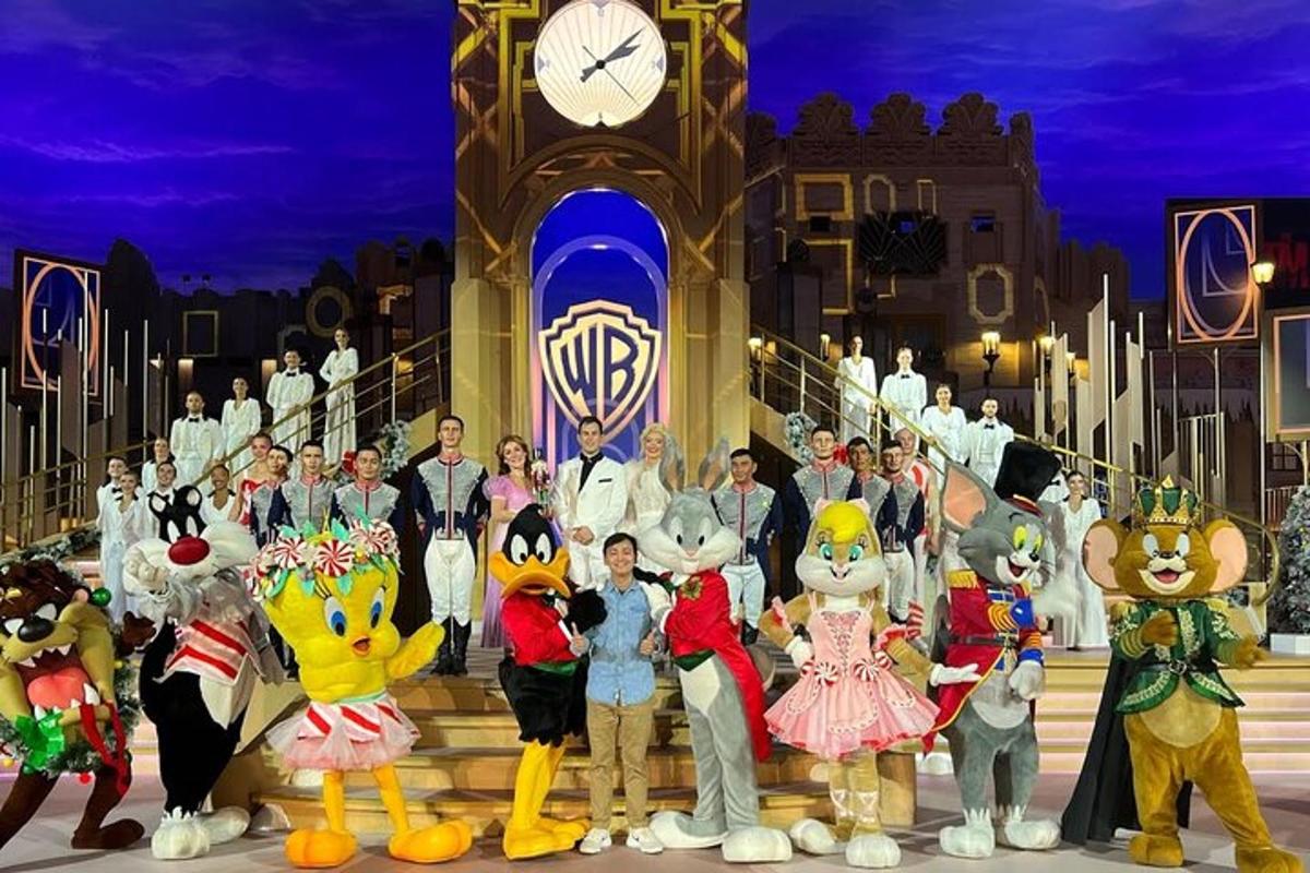 a group of people dressed in mascots in front of a clock