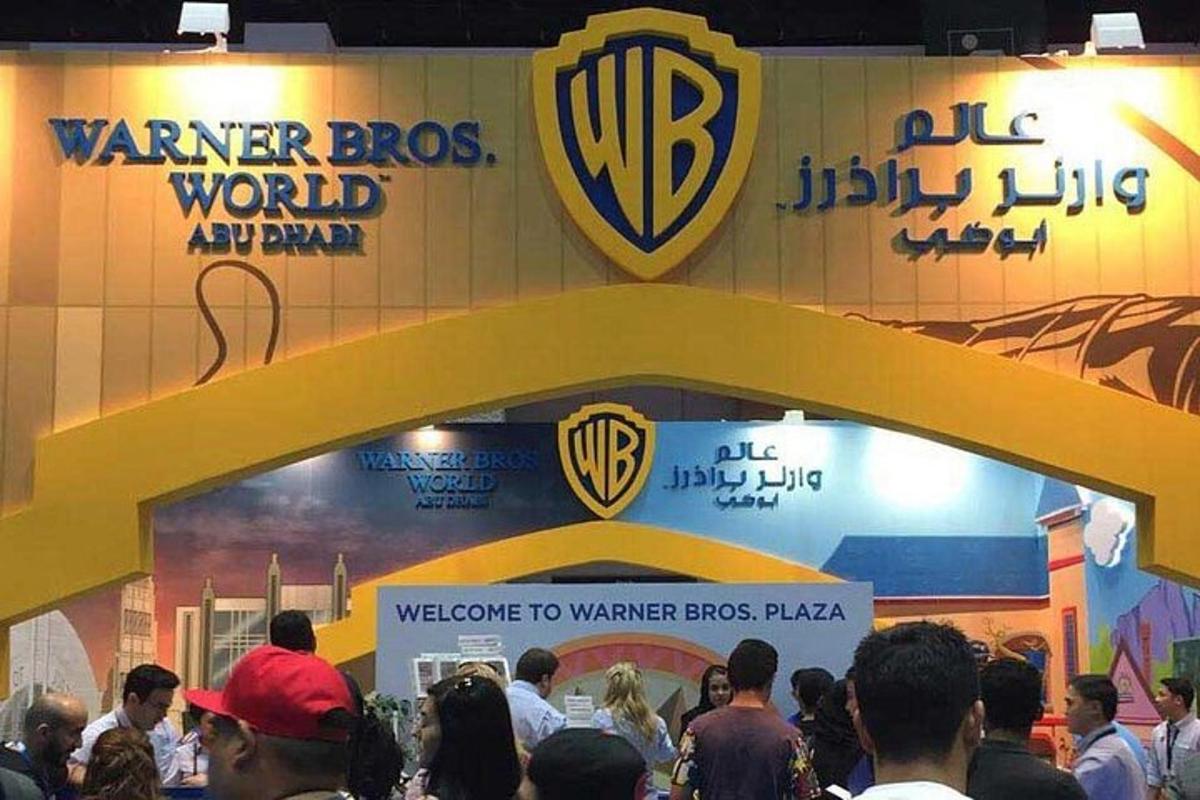 a crowd of people standing in front of a sign