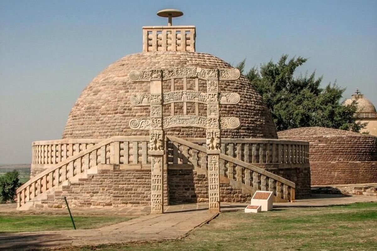 a large building with a staircase in the grass