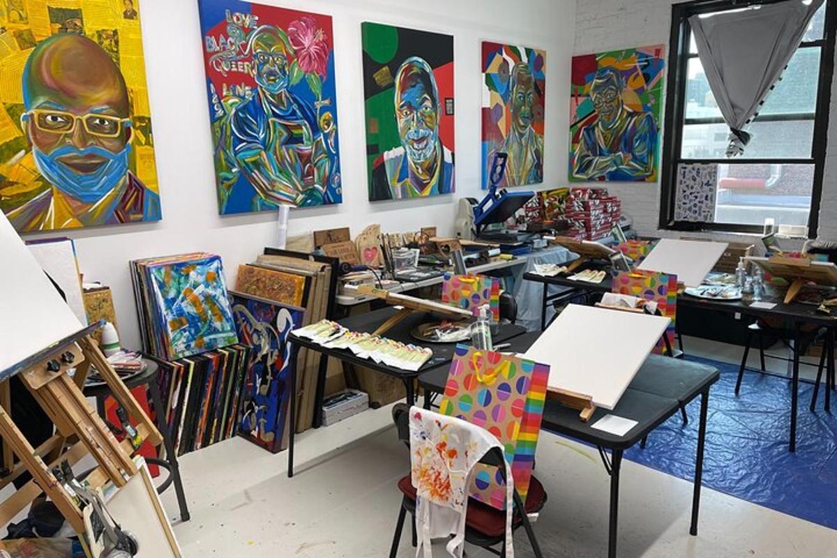 an art room with paintings on the wall and tables