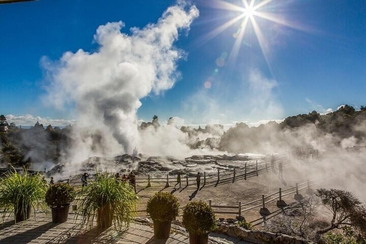 a view of a geyser with the sun in the sky