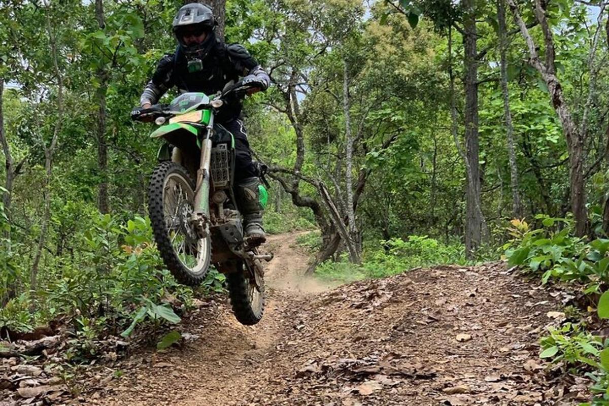 a person riding a dirt bike on a dirt trail