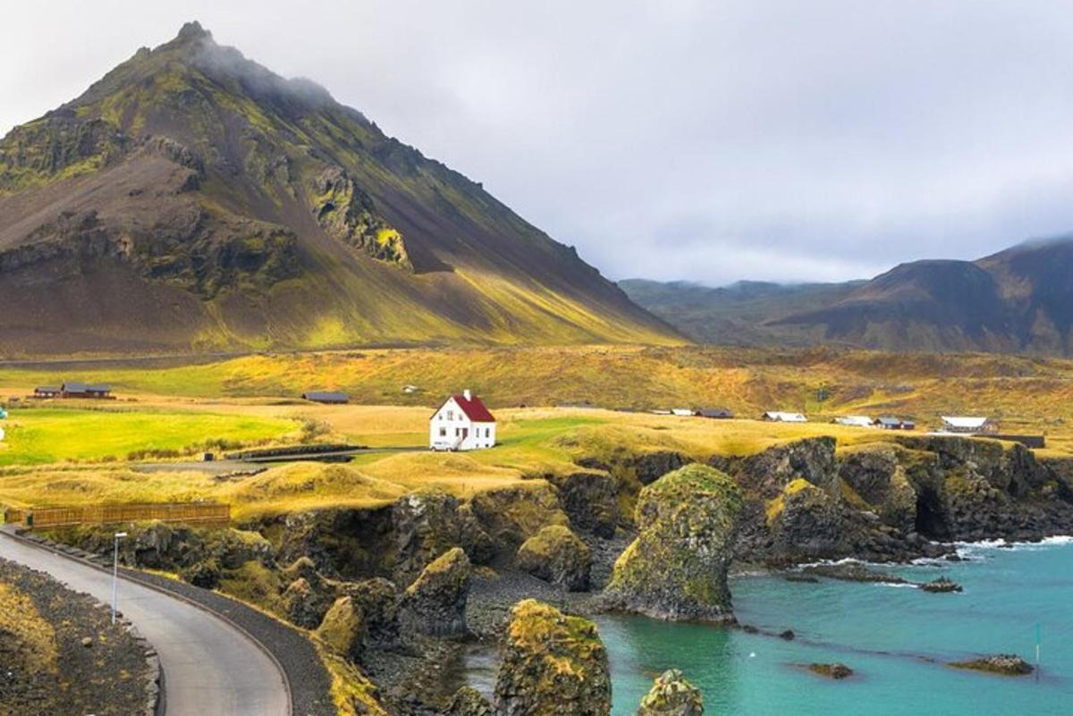 a small white house on the side of a mountain