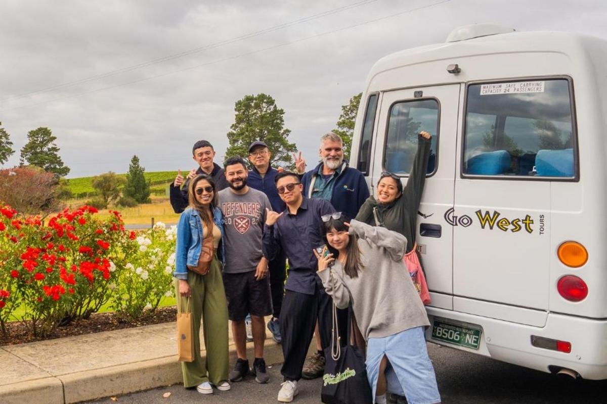 a group of people standing in front of a van