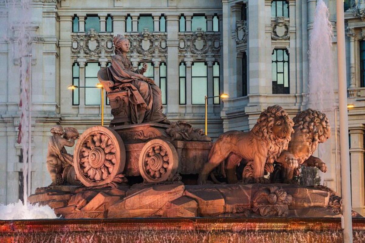 a fountain with a statue in front of a building