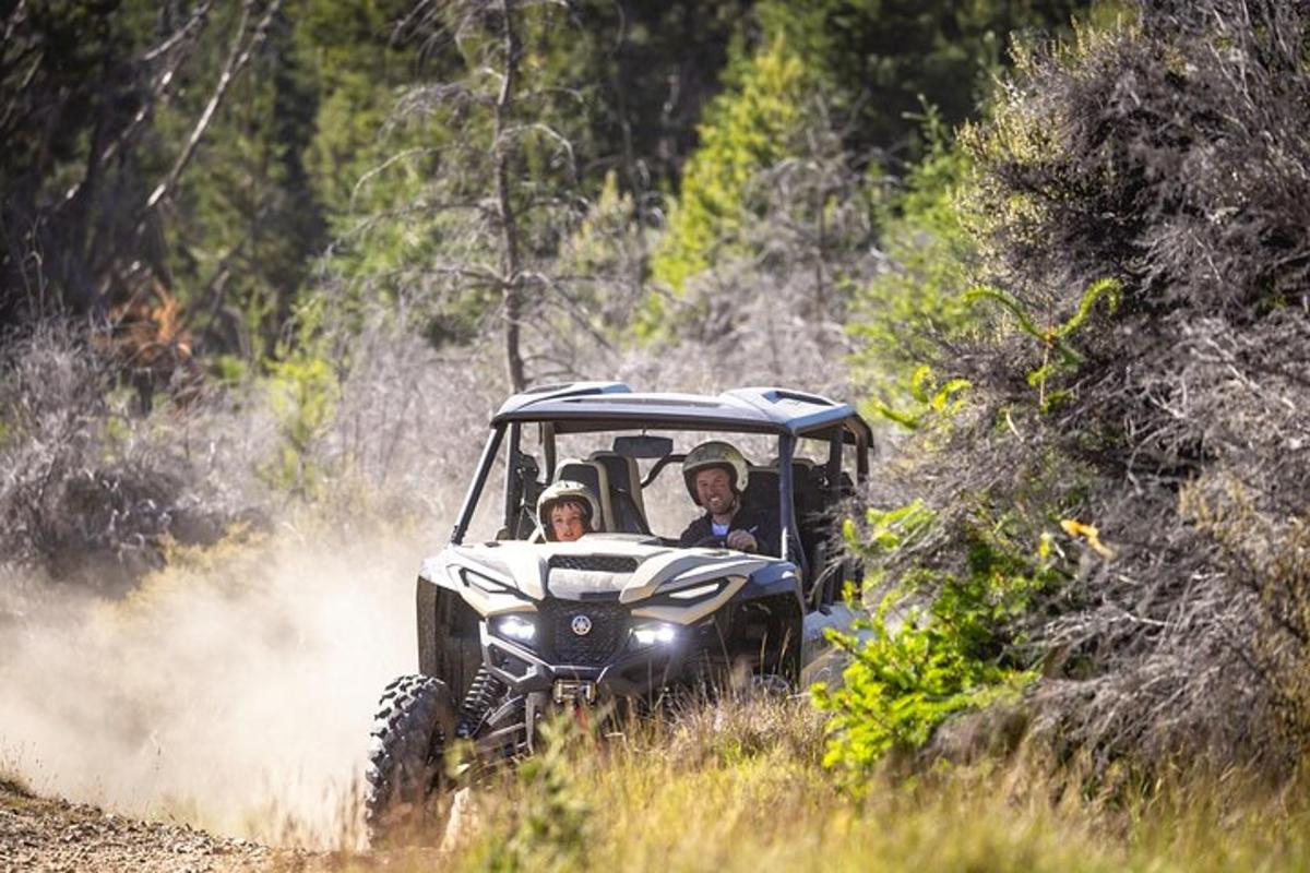 kaks inimest ATV-s mööda kruusateed sõitmas