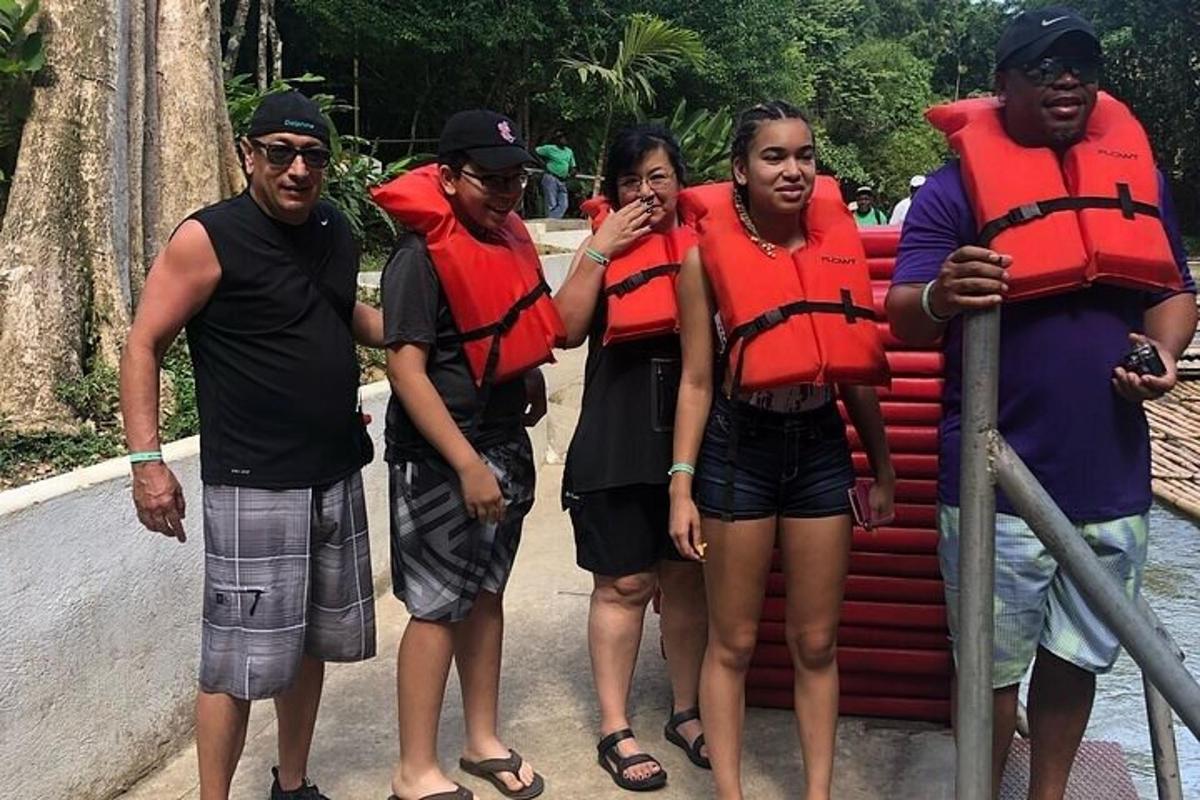 a group of people wearing life jackets standing next to a bench