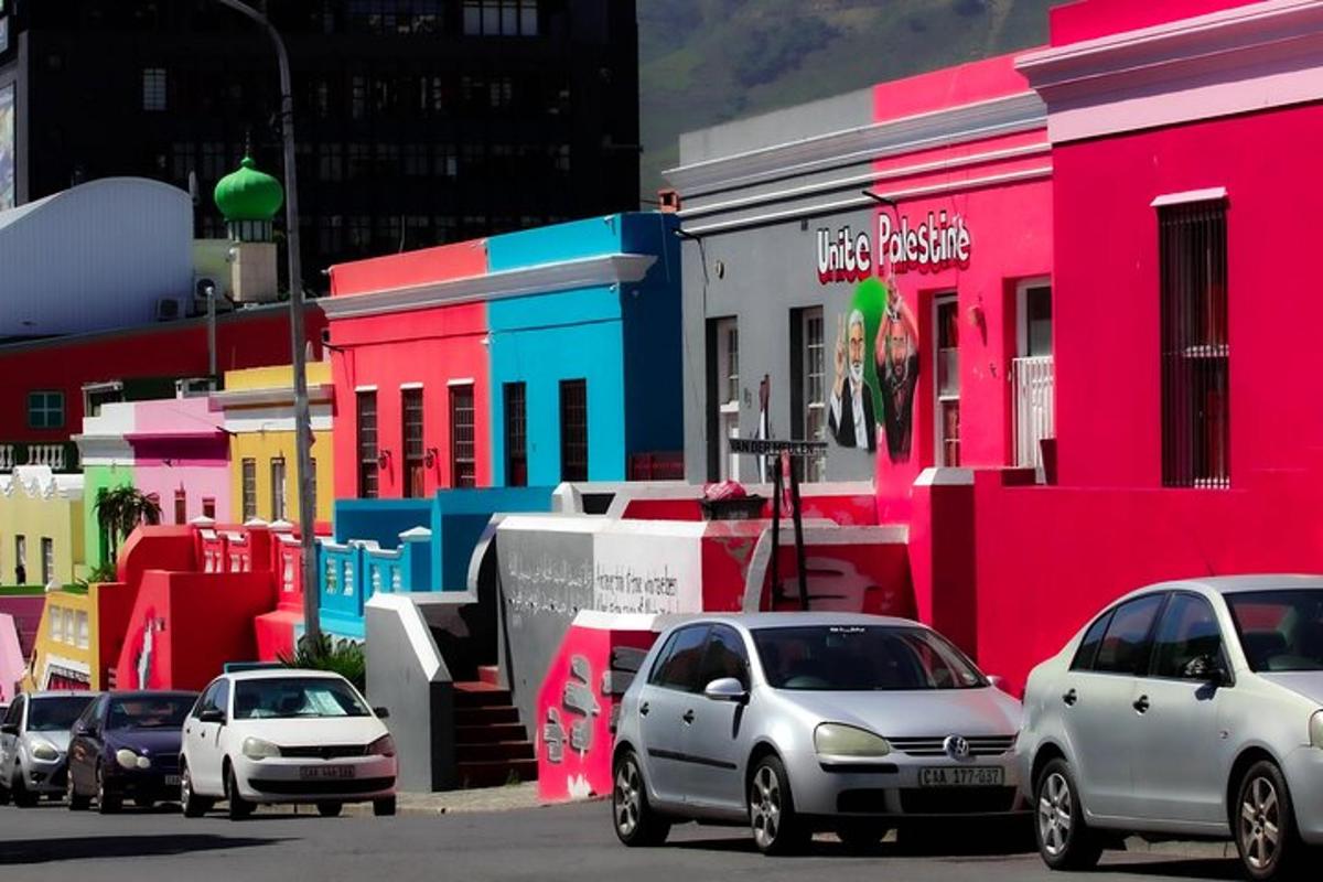 a group of cars parked in front of colorful buildings