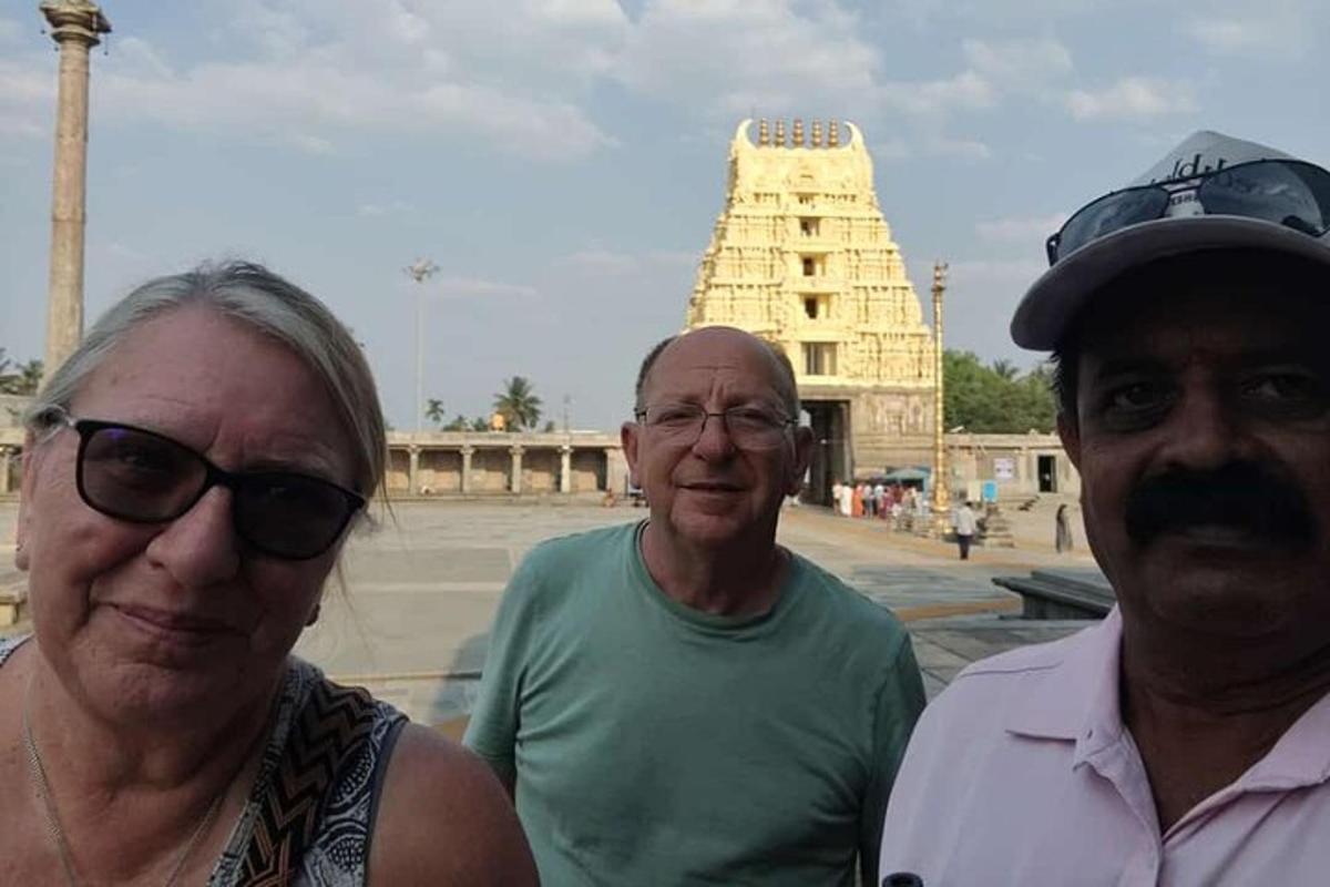 two men and a woman standing in front of a building